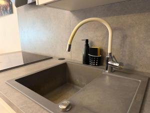 a sink in a kitchen with a faucet at Seafront Apartment Bakar in Bakar +25 photos