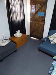 a room with a door and a table with a vase on it at Cozy Corner Unit 1 and unit 2 in Bredasdorp