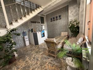 a living room with chairs and a refrigerator at Delfin Hotel Restaurant Spa Ailevi in Ganja