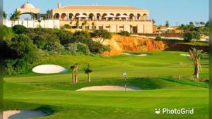 a view of a golf course with a resort at Sunny Beach Praia da Rocha Sea Views Algarve in Portimão