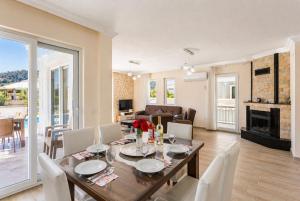 a dining room and living room with a table and chairs at Villa Veli in Dalyan