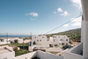 a view from the balcony of a white building at Golden View Suites with hot tub in Vóthon