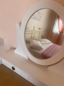 a bedroom with a large mirror on the wall at Isidora Hotel in Agia Marina Aegina +40 photos