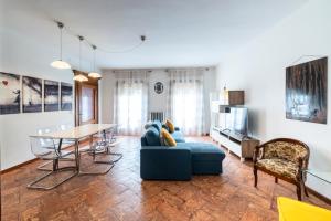 a living room with a blue couch and a table at Palazzo Rivola in Bergamo
