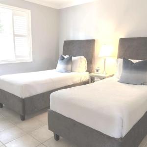 a bedroom with two beds and a window at Lantern Hill & Hollow in Ingonish Beach +61 photos