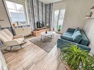 a living room with a couch and two chairs and a tv at Apartment Feli by Interhome in Steinheim