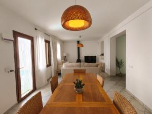 a living room with a wooden table and chairs at Ca Na Margalida in Muro