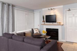 a living room with a couch and a fireplace at Beautiful Mountain Studio in The Blue Mountains in Blue Mountains