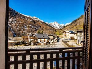a view from a balcony of a town with mountains at Appartamento Alta Valle Maira - Nebin in Villaro
