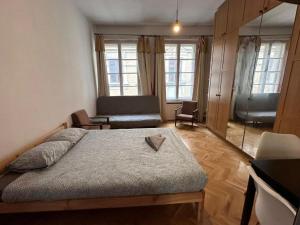 a bedroom with a bed and a living room at Wrocławska Rooms in Poznań