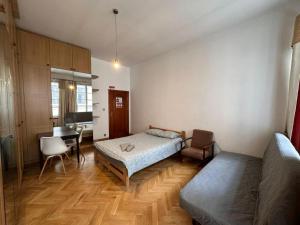 a bedroom with a bed and a desk and a table at Wrocławska Rooms in Poznań +5 photos