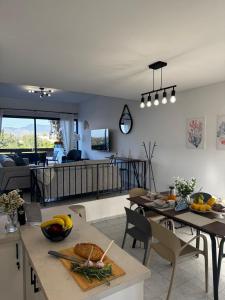 a kitchen and living room with a table and chairs at KOHILI Seaside Residence in Polis Chrysochous