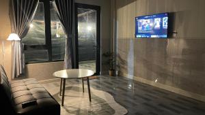 a living room with a table and a tv at Nhà bạn Nhí in Khu Chi Lăng +19 photos