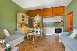 a kitchen and living room with a couch and a table at Pino Vallegrande in Procchio