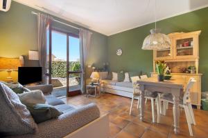 a living room with a couch and a table at Pino Vallegrande in Procchio