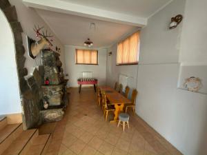 a dining room with a wooden table and chairs at Domek Przy Potoku in Biały Dunajec +31 photos