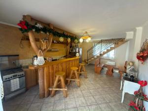 a kitchen with a counter and stools in a room at Domek Przy Potoku in Biały Dunajec