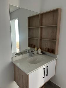 a bathroom with a sink and a mirror at St Francis Links- Gallery Deck Links Villas in St Francis Bay +40 photos