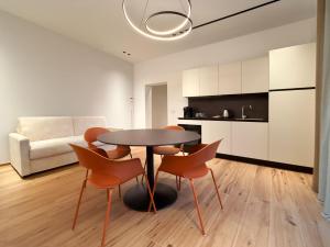 a kitchen and living room with a table and chairs at BOREMA Apulian Rooms in Andria