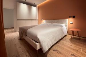 a bedroom with a large white bed and a table at BOREMA Apulian Rooms in Andria
