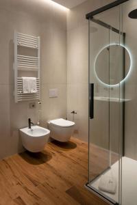 a bathroom with a toilet and a sink and a shower at BOREMA Apulian Rooms in Andria +24 photos