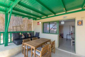 a living room with a table and a couch at Casita Darmelo in Costa Calma