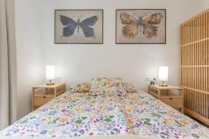 a bedroom with three pictures of butterflies on the wall at Casita Darmelo in Costa Calma +34 photos