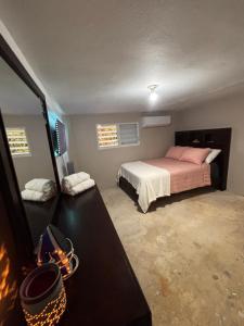 a bedroom with a bed and a dresser in it at Casa Campo Vieques PR in Vieques