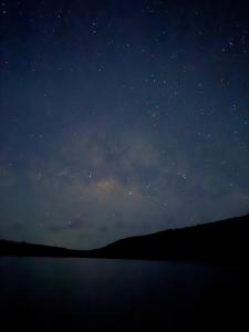 a night sky with stars over a body of water at Casa Campo Vieques PR in Vieques +2 photos