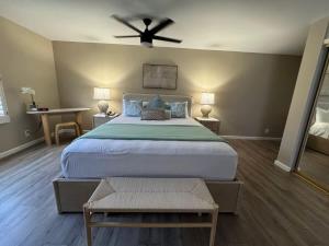 a bedroom with a large bed with a ceiling fan at 2 Bedroom OceanView Condo Pono Kai Resort E103 in Kapaa