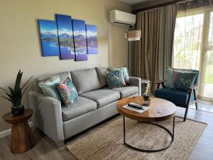 a living room with a couch and a table at 2 Bedroom OceanView Condo Pono Kai Resort E103 in Kapaa