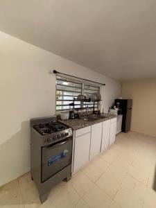 a kitchen with a stove and a counter top at Casa Campo Vieques PR in Vieques