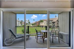 a balcony with a table and chairs and a table and chairs at Kauai Serenity Condo Pono Kai Resort E206 in Kapaa
