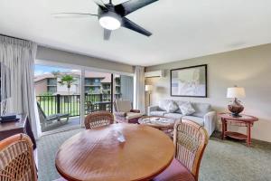 a living room with a table and a couch at Kauai Serenity Condo Pono Kai Resort E206 in Kapaa