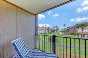 a balcony with a chair and a view of a street at Kauai Serenity Condo Pono Kai Resort E206 in Kapaa +41 photos