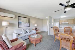 a living room with a couch and a table at Kauai Serenity Condo Pono Kai Resort E206 in Kapaa
