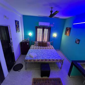 a bedroom with a bed in a blue room at The Human Nest Coliving in Bhubaneshwar