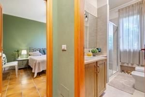 a bathroom with a sink and a bed in a room at Pino Vallegrande in Procchio +16 photos