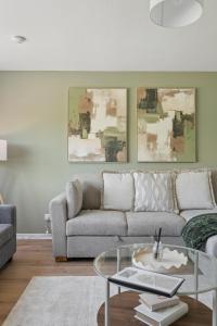 a living room with a couch and a glass table at Lime Grove House in Dalkeith