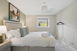a bedroom with a white bed with a window at Lime Grove House in Dalkeith +33 photos