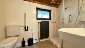 a bathroom with a sink and a toilet and a shower at Kleine Auszeit Buchholz in Buchholz in der Nordheide +23 photos