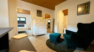 a living room with a dresser and a bedroom at Kleine Auszeit Buchholz in Buchholz in der Nordheide