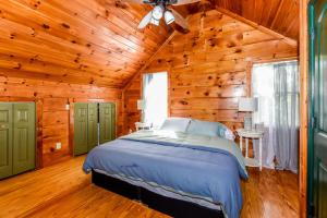 a bedroom with a bed in a wooden room at Tree Tops in Townsend