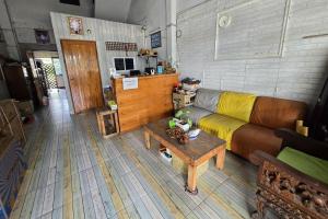 a living room with a couch and a table at Malai Place Lampang in Lampang