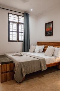 a bedroom with two beds and a window at Nyumbani Stonetown in Zanzibar City