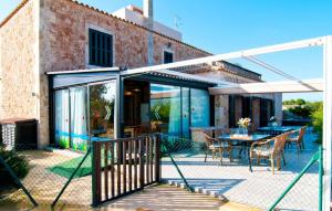 a glass extension of a house with a patio at Sa Palmaria Dos in Can Picafort