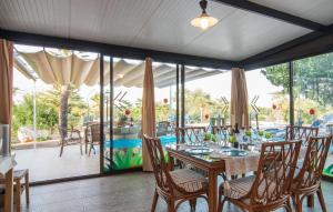 a dining room with a table and chairs at Sa Palmaria Dos in Can Picafort +34 photos