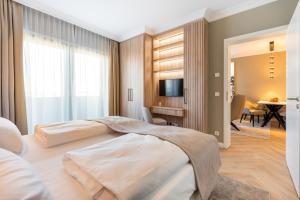 a bedroom with two beds and a living room at Yachthafen Barth - Ferienwohnung und Penthouses in Barth