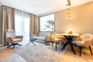 a living room with a couch and chairs and a table at Yachthafen Barth - Ferienwohnung und Penthouses in Barth
