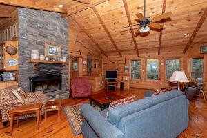 a living room with a couch and a fireplace at Hayloft in Townsend